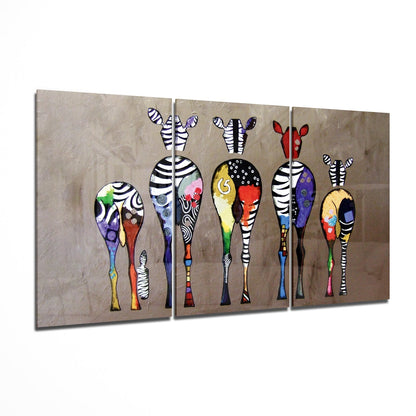Three-panel glass wall art displaying colorful stylized zebras with striped legs and patterned bodies against textured beige background.