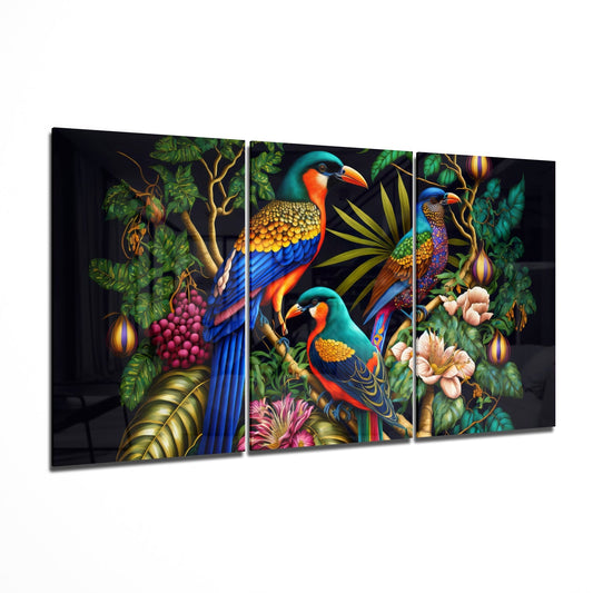Three-panel glass wall art displaying colorful tropical birds perched among flowering vines and foliage against a dark background, shown at an angle.