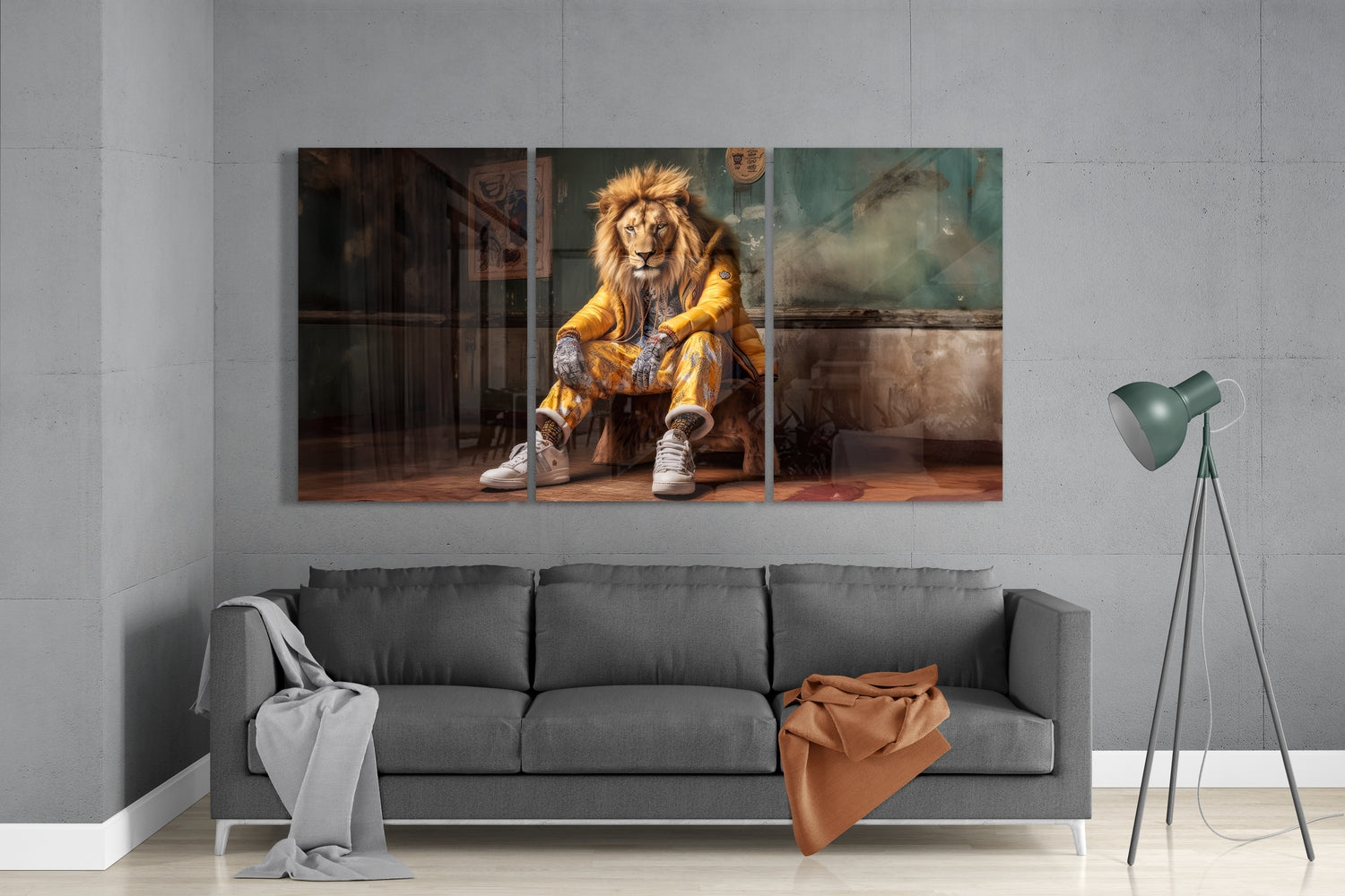 Multi-panel glass wall art displaying a lion wearing gold jacket and white sneakers seated indoors, hung above gray sofa in minimalist room.