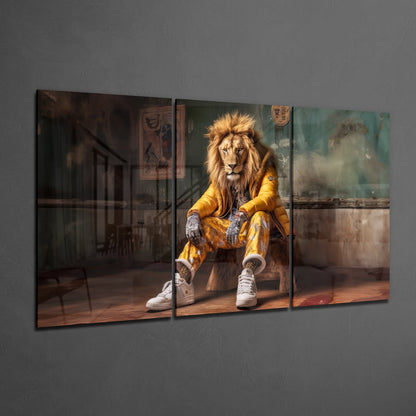 Three-panel glass wall art displaying a lion in gold jacket and white sneakers seated in an urban interior setting.