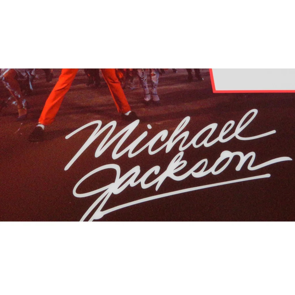 Michael Jackson autographed contract framed display with white cursive signature on dark red background