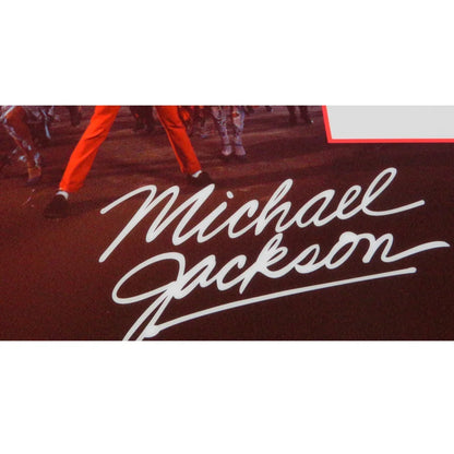 Michael Jackson autographed contract framed display with white cursive signature on dark red background