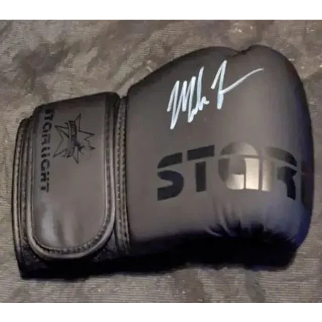 Black boxing glove with white autograph showcasing Mike Tyson auto signed collectible card