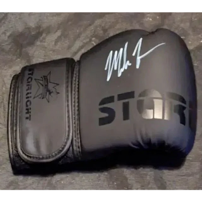 Black boxing glove with white autograph showcasing Mike Tyson auto signed collectible card