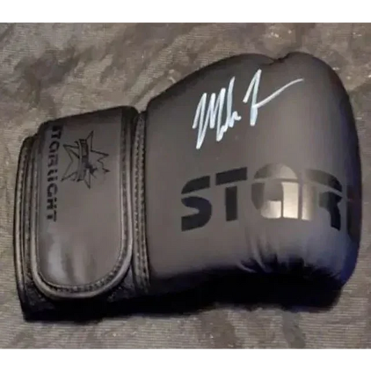 Black boxing glove with white autograph showcasing Mike Tyson auto signed collectible card