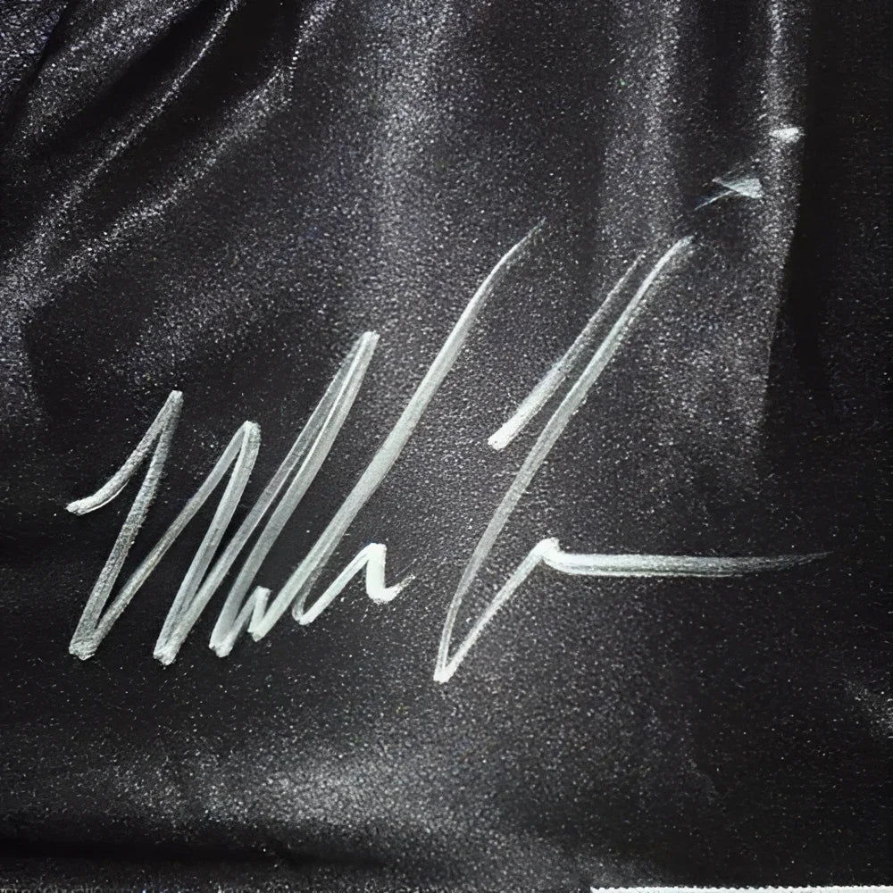 Mike Tyson autographed black boxing trunks with white signature on satin