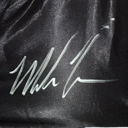 Mike Tyson autographed black boxing trunks with white signature on satin