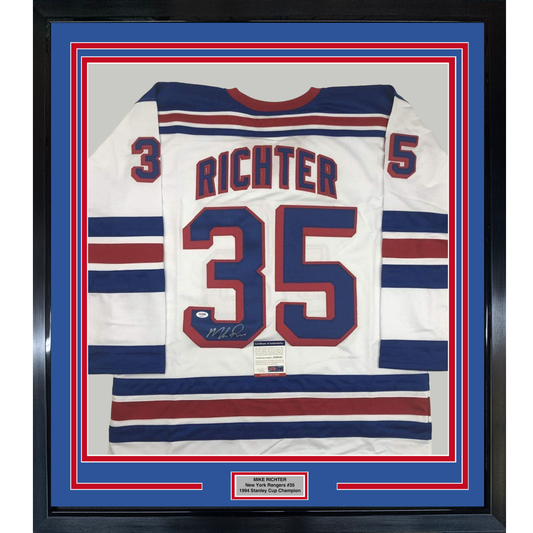 Framed white New York Rangers hockey jersey #35 with "RICHTER" nameplate, navy and red stripes, signed, displayed against blue matting with red border frame.
