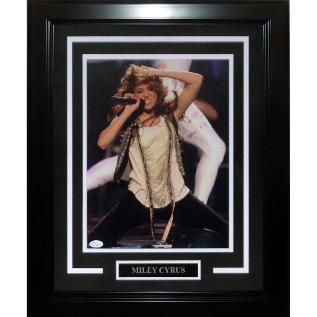 Miley Cyrus autographed 11x14 photo in black frame with white mat and silver plaque