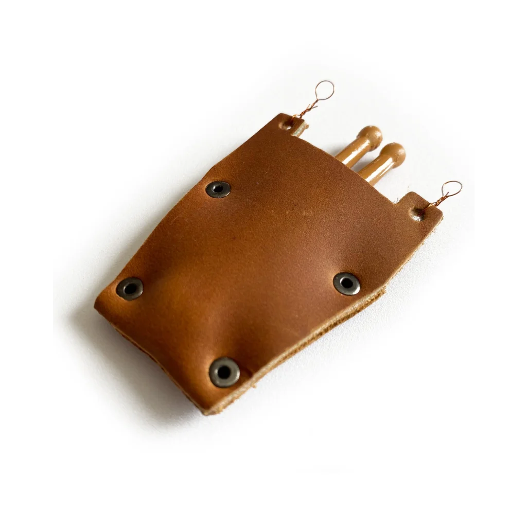 Mini leather drumstick bag with brown leather pouch and metal grommets