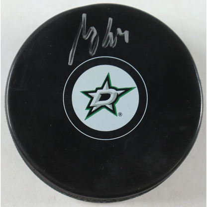 Black Dallas Stars logo hockey puck with white and green Stars logo for collectible fans