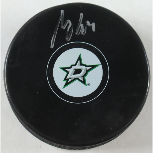 Black Dallas Stars logo hockey puck with white and green Stars logo for collectible fans
