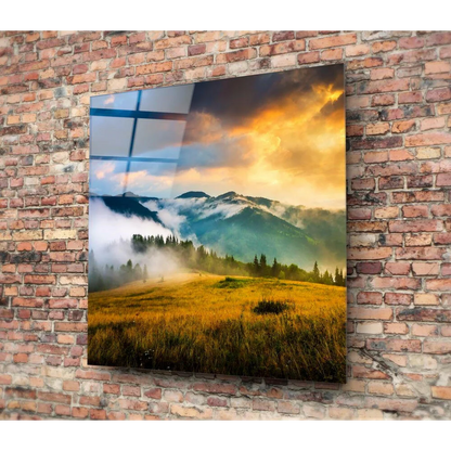 Misty Mountain glass wall art with golden meadows and blue sky