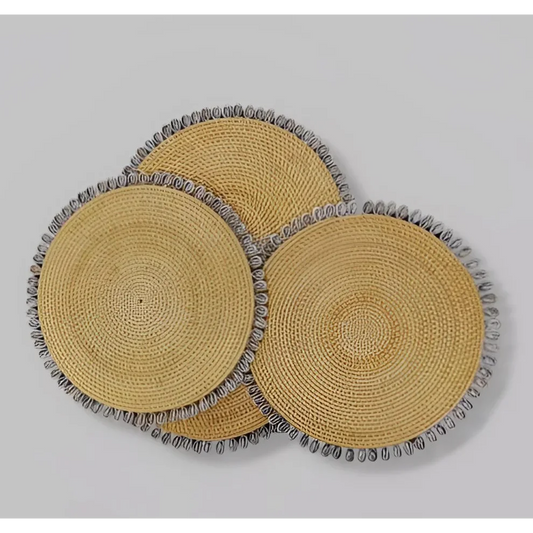 Three round Mode Living Shell placemats with woven fringe for stylish dining setup