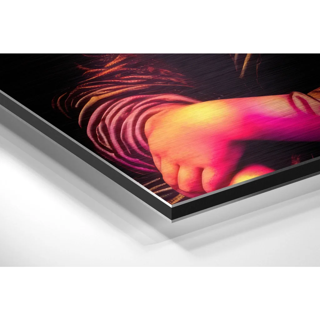 Vibrant hand gripping red orange swirls on brushed aluminium dibond print