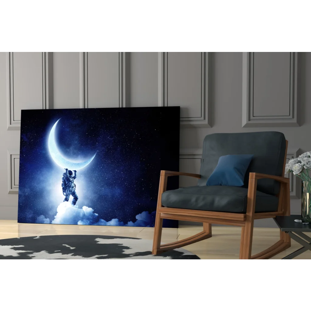 Stunning glass wall art of astronaut holding crescent moon in starry sky