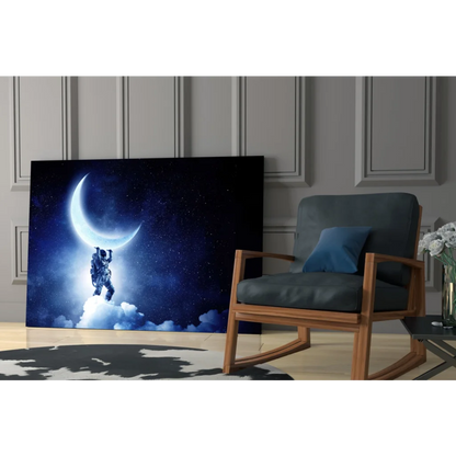 Stunning glass wall art of astronaut holding crescent moon in starry sky