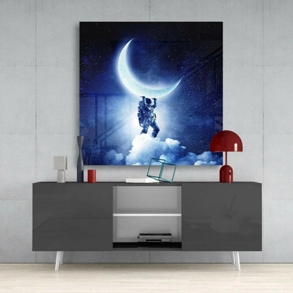 Astronaut reaching for glowing crescent moon on dreamy starry night glass wall art