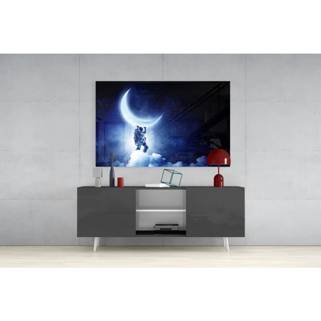 Black-and-white astronaut on crescent moon glass wall art print