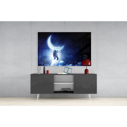 Black-and-white astronaut on crescent moon glass wall art print