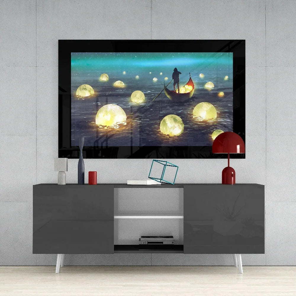 Black-framed glass wall art of silhouette boat navigating glowing orbs on water under teal sky