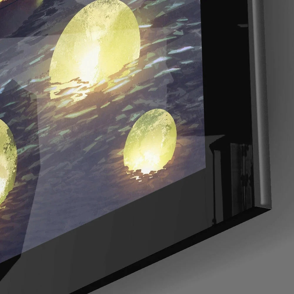 Glowing golden lanterns on rippling water glass wall art with black frame