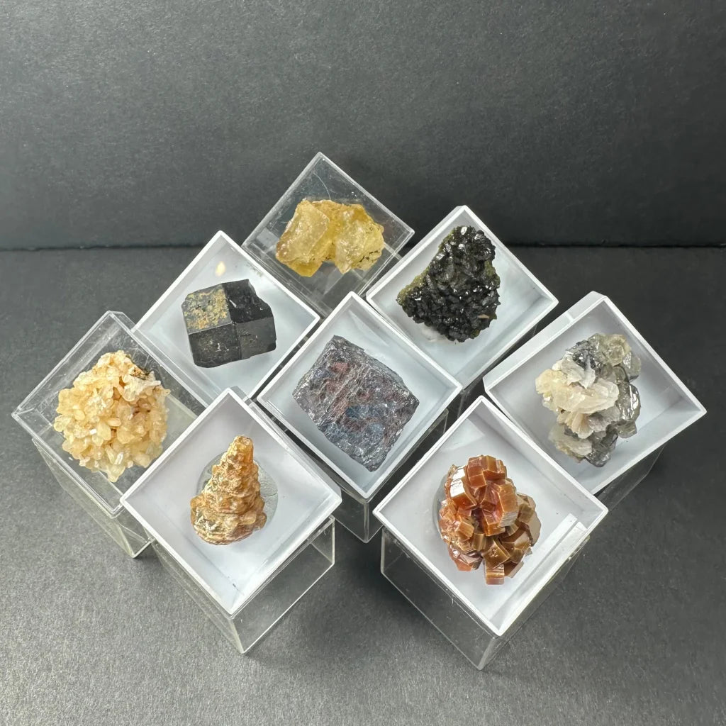 Seven Moroccan thumbnail specimens in acrylic box cubes