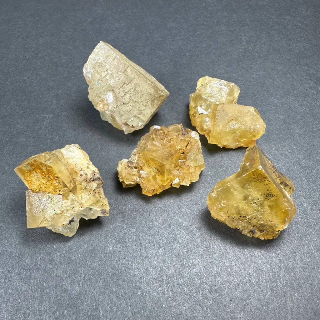 Yellow translucent fluorite thumbnail specimens in acrylic box