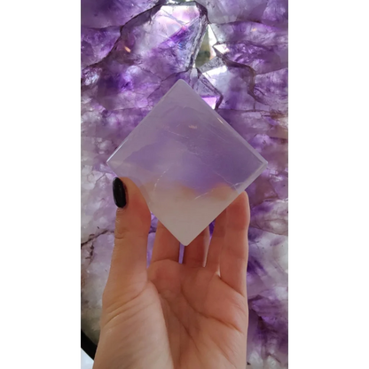 Hand holding translucent Moroccan selenite crystal cube, 470g natural decor