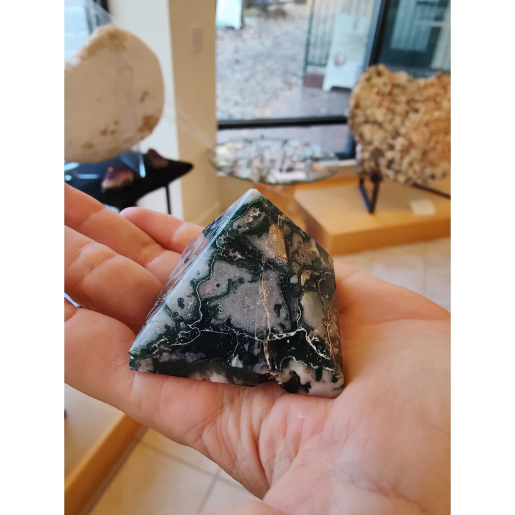 Polished moss agate pyramid India with swirling black and white patterns