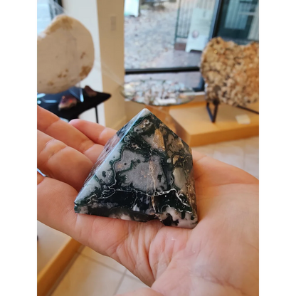 Polished moss agate pyramid India with swirling black and white patterns