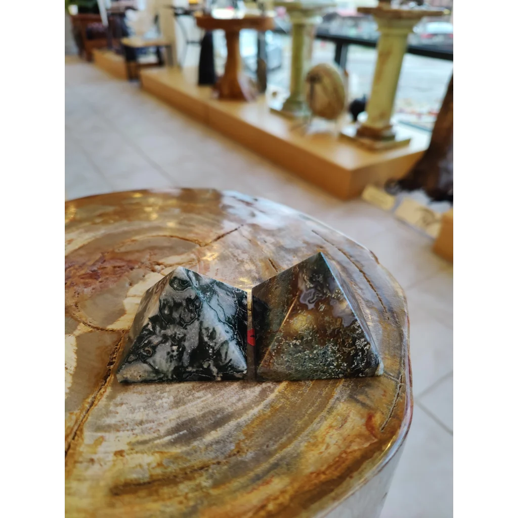 Moss agate pyramid India on rustic wood with black white swirls