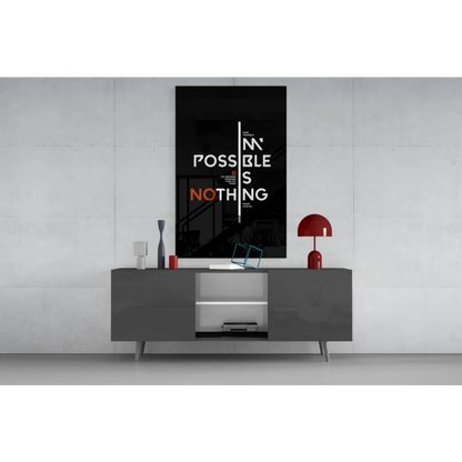 Bold black motivational wall art poster with impossible is nothing typography above gray console