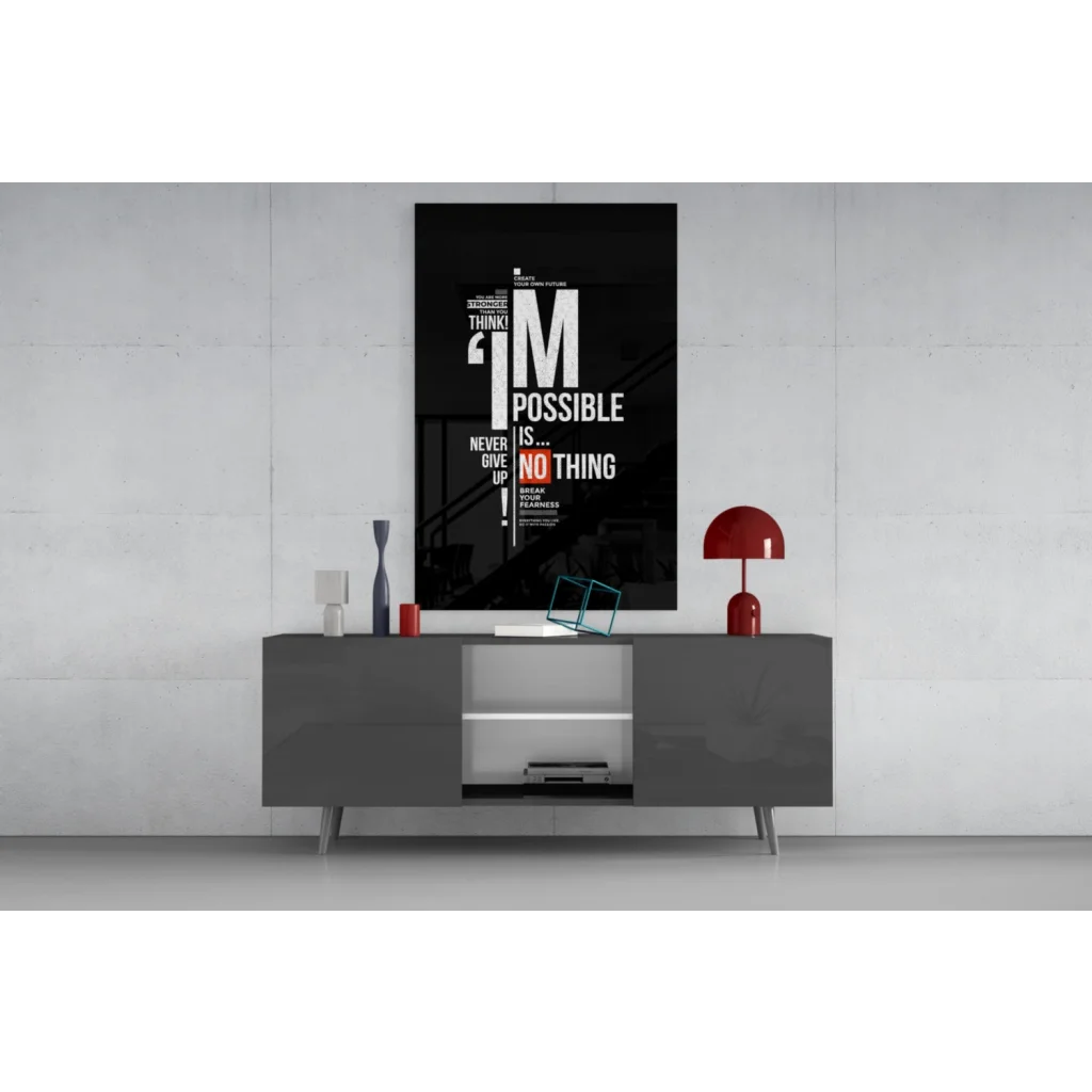 Black glass wall art motivational poster with bold white orange text on gray table