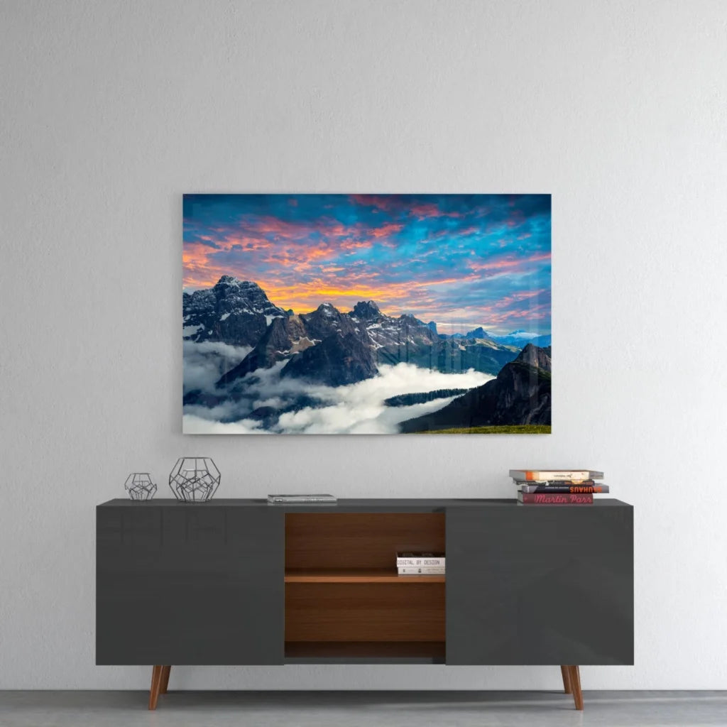 Stunning mountain sunset glass wall art with snow-capped peaks and dramatic sky