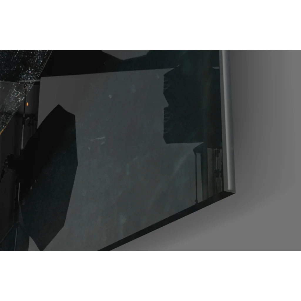 Cracked dark-tinted glass wall art in silver frame on orange canvas