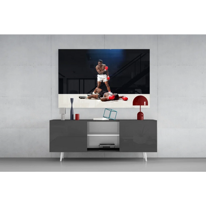 Sleek gray media console under Muhammad Ali knockout wall art