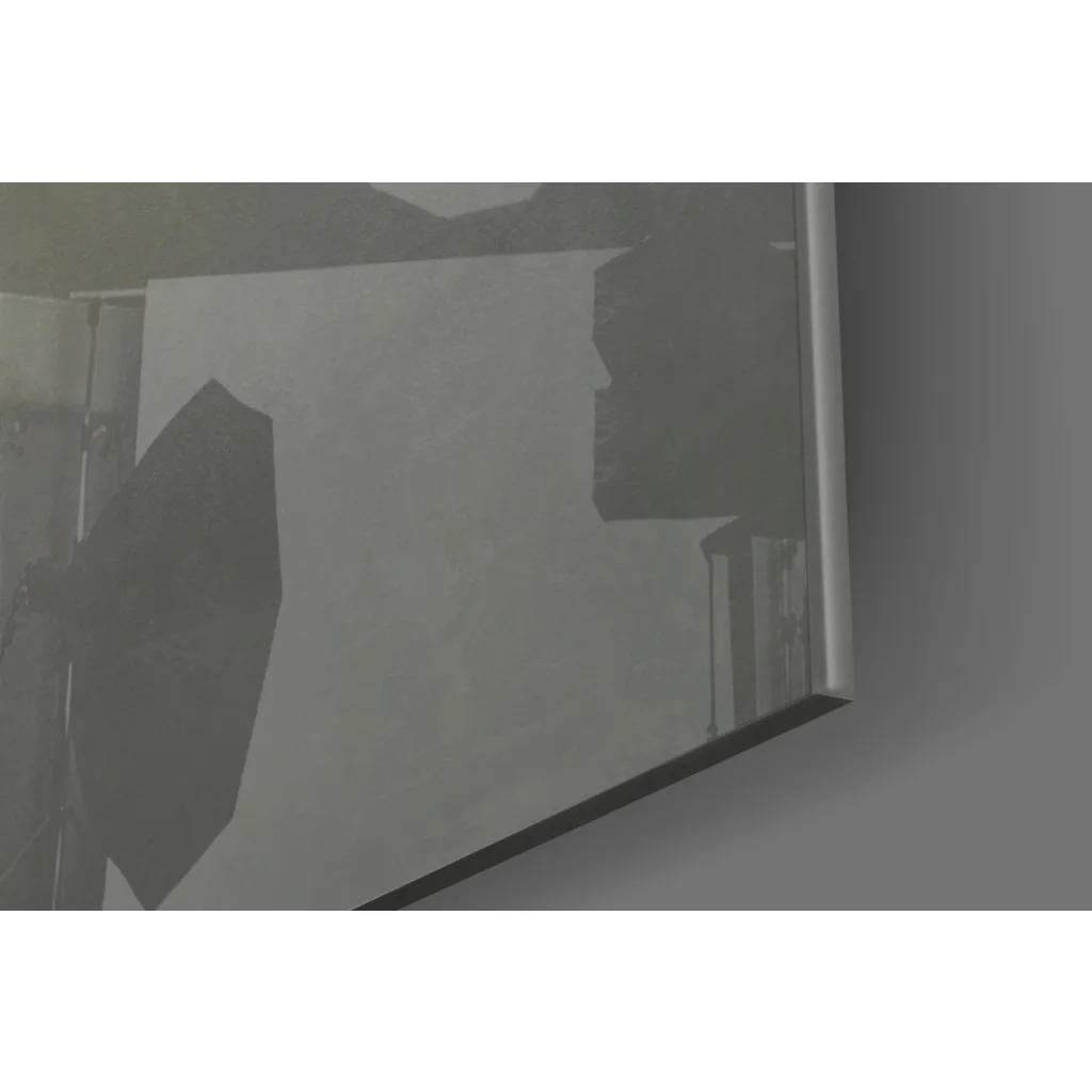 Sleek silver-framed glass wall art mirror with faint studio shadows