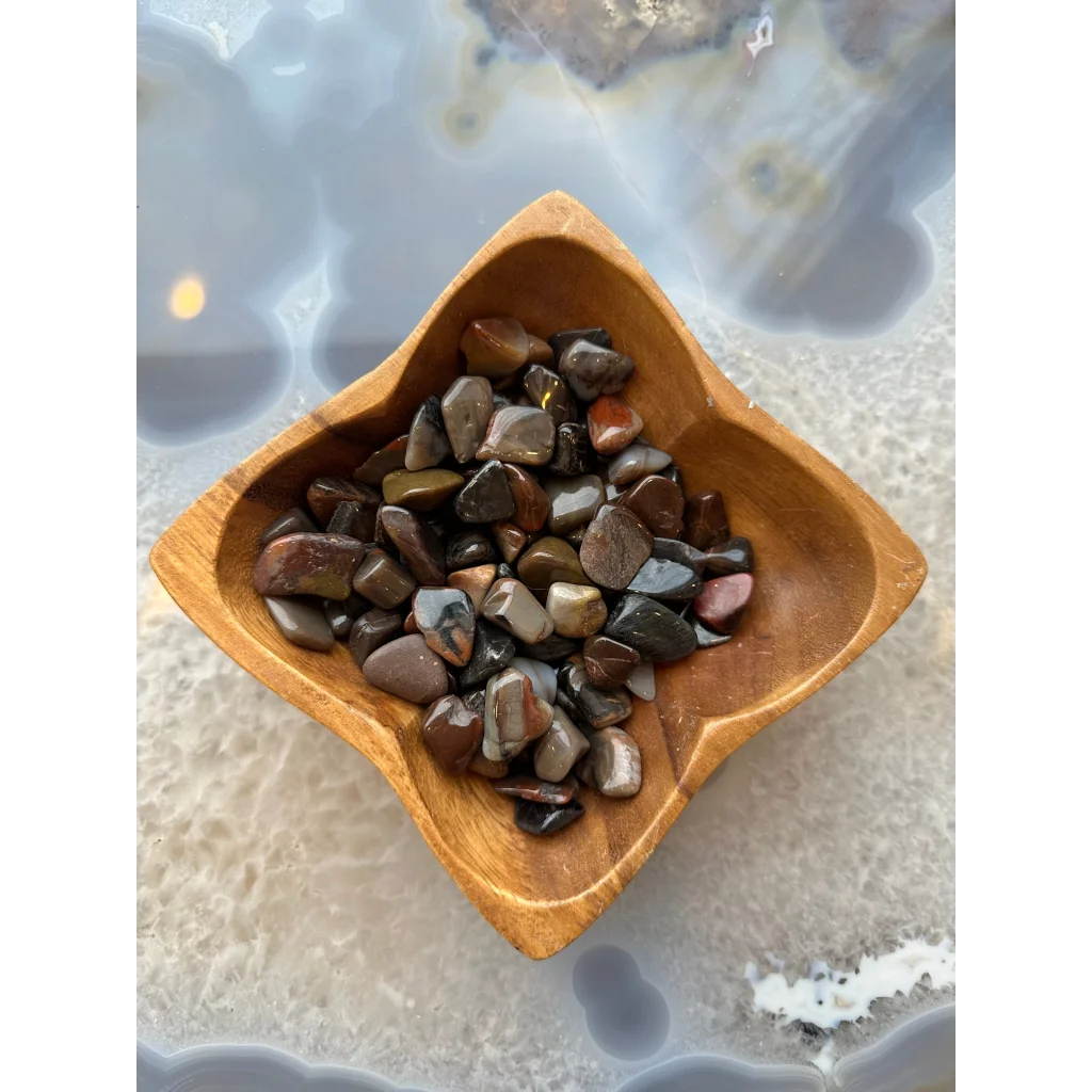 Natural agate tumbled stone collection in earthy tones bowl