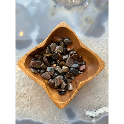 Natural agate tumbled stone collection in earthy tones bowl