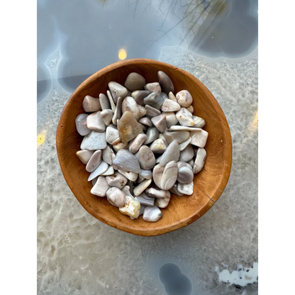 Wooden bowl of light gray white natural agate tumbled stones