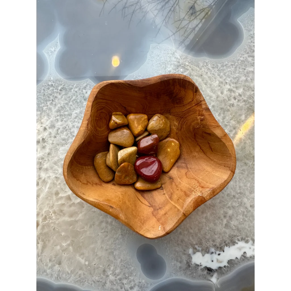 Handcrafted wooden bowl holding Natural Agate tumbled stones in earthy tones