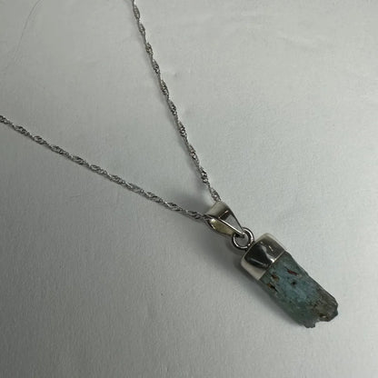 Natural aquamarine beryl sterling silver pendant with raw teal gem
