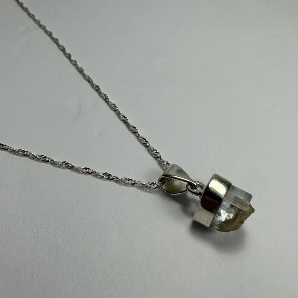 Natural aquamarine beryl sterling silver pendant with raw greenish-yellow crystal