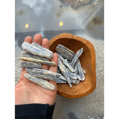 Hand holding natural blue kyanite crystal blade from Brazil