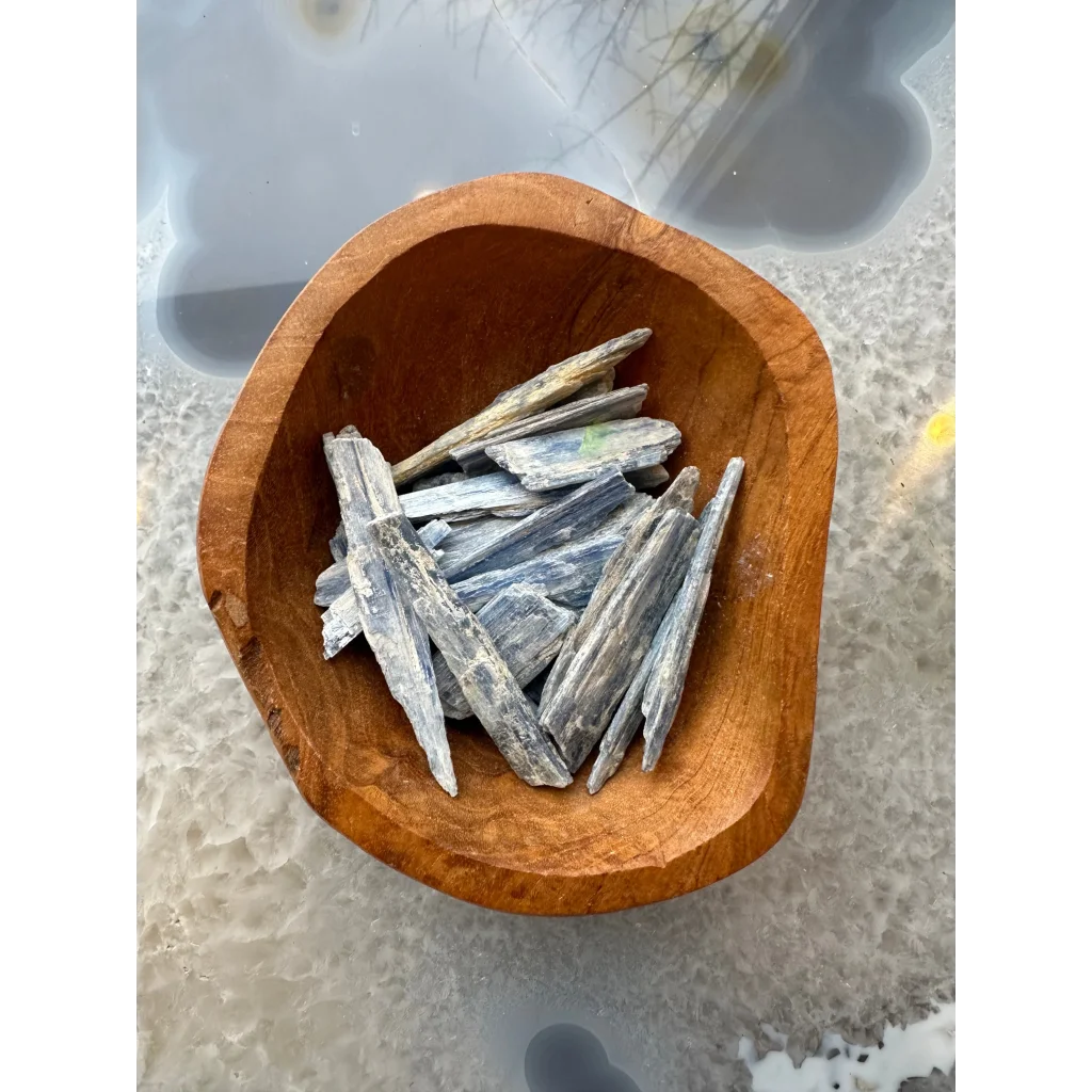 Rustic wooden bowl with jagged blue kyanite crystal shards from Brazil