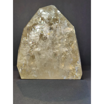 A natural citrine polished point 4.1kg with a translucent pale yellow rough faceted surface and internal inclusions