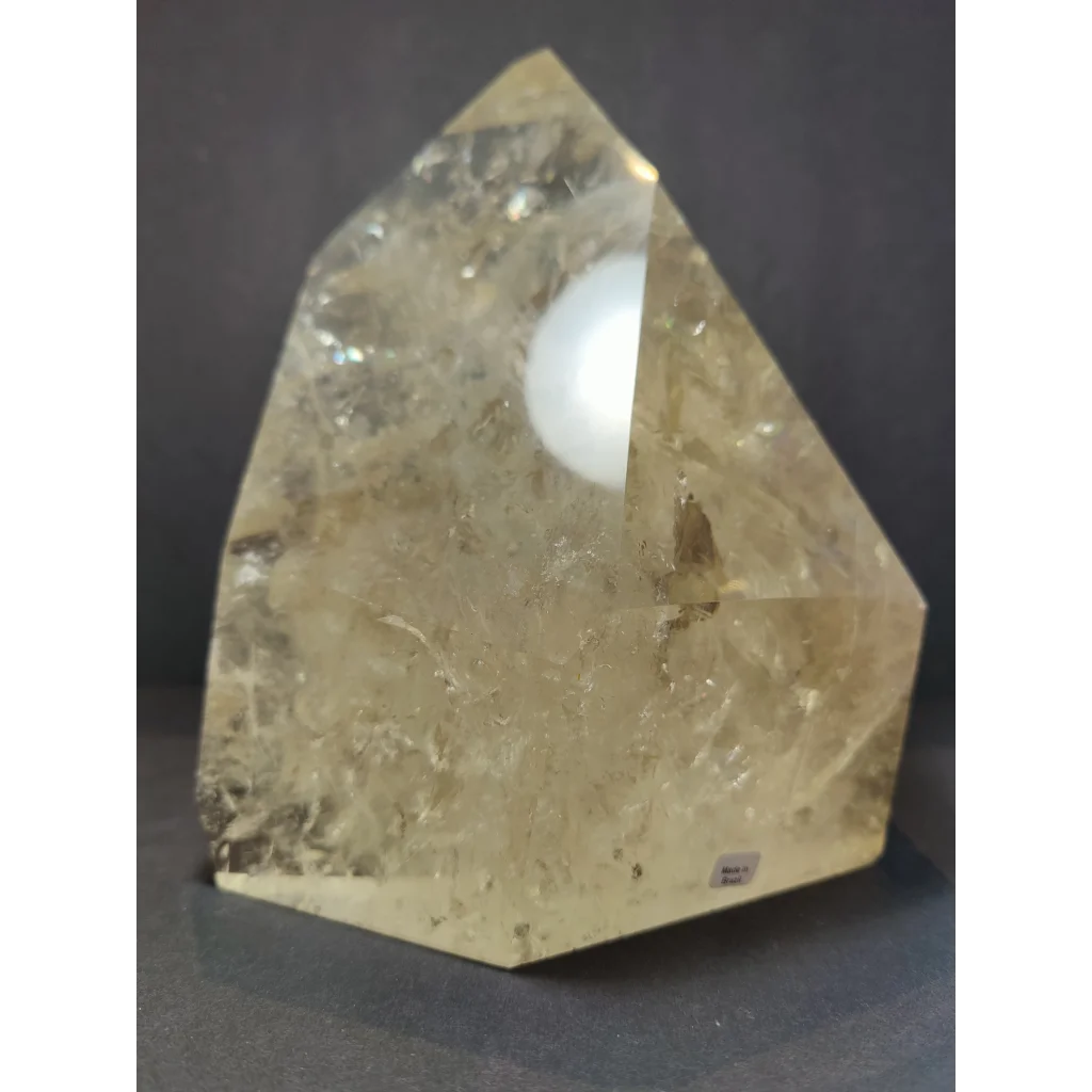 Natural citrine polished point 4.1kg with a translucent pale yellow faceted pyramid shape and internal inclusions
