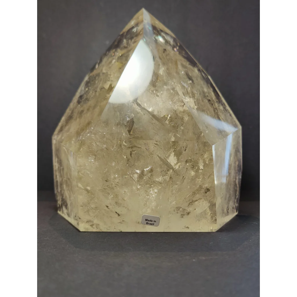 Natural citrine polished point weighing 4.1kg with a translucent pale yellow faceted pyramid shape and internal inclusions