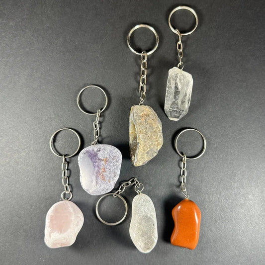 Set of 7 natural crystal keychains with raw gemstones like quartz and amethyst